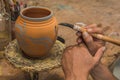 Mexican potter craftsman, working the clay with his hands