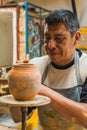 Mexican potter craftsman, working the clay with his hands