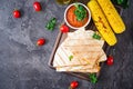 Mexican Quesadilla wrap with chicken, corn and sweet pepper and tomato sauce. Royalty Free Stock Photo