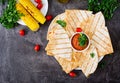 Mexican Quesadilla wrap with chicken, corn and sweet pepper and tomato sauce. Royalty Free Stock Photo