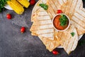 Mexican Quesadilla wrap with chicken, corn and sweet pepper and tomato sauce. Royalty Free Stock Photo