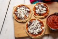 Mexican red sopes with cheese and beans on white background