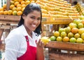 Mexican saleswoman offering fruits on a farmers market Royalty Free Stock Photo