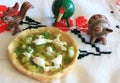 Mexican Salsa Verde Gordita and clay animal figurines Royalty Free Stock Photo