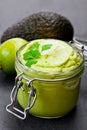 Mexican sauce guacamole in a jar on black stone background Royalty Free Stock Photo