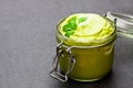 Mexican sauce guacamole in a jar on black stone background Royalty Free Stock Photo