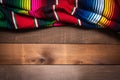 Mexican Serape blanket on wood Background Royalty Free Stock Photo