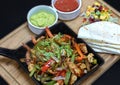 Mexican sizzling fajitas on a wood board