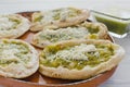 Mexican sopes with grated cheese and green salsa, mexican food spicy in mexico