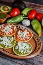 Mexican sopes with grated cheese and salsa, Traditional breakfast in Mexico