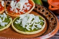 Mexican sopes with grated cheese and salsa, Traditional breakfast in Mexico