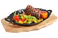 Mexican steak with vegetables in cast iron oval serving platter.