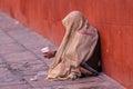 Mexican street beggar woman with head covered