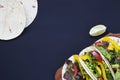 Mexican street tacos flat lay composition with beef and vegetables.