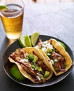 Mexican street tacos with pork carnitas, red cabbage, cilantro and onion Royalty Free Stock Photo