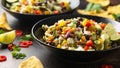 Mexican style salad of black beans, lentils, corn, tomato and lettuce with a salsa and tortilla chips Royalty Free Stock Photo