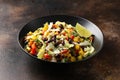 Mexican style salad of black beans, lentils, corn, tomato and lettuce with a salsa and tortilla chips Royalty Free Stock Photo