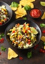 Mexican style salad of black beans, lentils, corn, tomato and lettuce with a salsa and tortilla chips Royalty Free Stock Photo