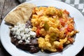 Mexican style scrambled eggs with fried beans, cheese and jalapeno