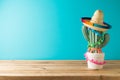 Mexican table decoration with cactus and sombrero hat over blue background. Cinco de Mayo holiday celebration Royalty Free Stock Photo