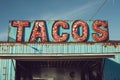 A mexican taco illuminated sign above a street food vendor truck. Royalty Free Stock Photo