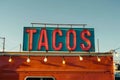 A mexican taco illuminated sign above a street food vendor truck. Royalty Free Stock Photo