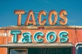 A mexican taco illuminated sign above a street food vendor truck. Royalty Free Stock Photo