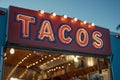 A mexican taco illuminated sign above a street food vendor truck. Royalty Free Stock Photo