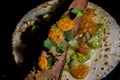 Mexican taco made with brisket, guacamole and vinaigrette