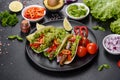 Mexican tacos with beef, tomatoes, avocado, onion and salsa sauce Royalty Free Stock Photo