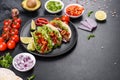 Mexican tacos with beef, tomatoes, avocado, onion and salsa sauce Royalty Free Stock Photo