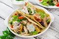 Mexican tacos with chicken, black beans and fresh vegetables and tartar sauce Royalty Free Stock Photo