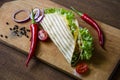 Mexican tacos with chicken meat, salad and vegetables sauce presented on a wooden board with a chilly pepper tomato and Royalty Free Stock Photo