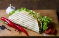 Mexican tacos with chicken meat, salad and vegetables sauce presented on a wooden board with a chilly pepper tomato and Royalty Free Stock Photo