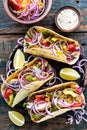 Tacos with chicken meat, vegetables and fresh greens