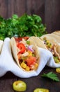 Mexican tacos with meat, corn, tomatoes, sweet pepper, red onions in a wheat tortilla Royalty Free Stock Photo