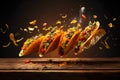 mexican tacos with nachos flying in air on dark background on wooden table