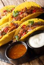 Mexican tacos stuffed with glazed chicken, microgreen and vegetables close-up. vertical