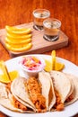 Mexican tacos on wooden background. Tacos and gin and tonic. Traditional Mexican food on wooden table. Shawarma concept with frenc