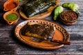 Mexican Tamales Oaxaquenos in banana leaves traditional from Oaxaca Mexico on wooden background