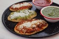Mexican tlacoyos with green and red sauce, Traditional food in Mexico Royalty Free Stock Photo