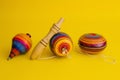 Mexican toys from Wooden, balero, yoyo and trompo in Mexico on a yellow background Royalty Free Stock Photo