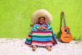 Mexican typical lazy topic man guitar poncho sit Royalty Free Stock Photo