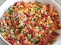 Mexican vegetable mixture. Pieces of pepper, carrots, corn and green peas. A colorful mix of the freshest and hottest vegetables