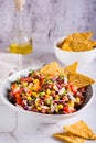 Mexican vegetable salad cowboy caviar and nachos in a bowl on the table. Vertical view Royalty Free Stock Photo
