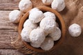 Mexican wedding cookies close up in a wooden bowl. Horizontal to