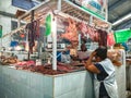 Mexican woman buying meat from a butcher at a local market in Teloloapan. Travel in Mexico