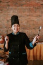 Mexican woman chef holding a spoon in mexican restaurant Royalty Free Stock Photo
