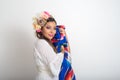 Mexican woman with flower headdress holding colorful serape.