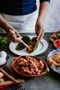 Mexican woman cooking chiles en nogada recipe with Poblano chili and ingredients, traditional dish in Puebla Mexico